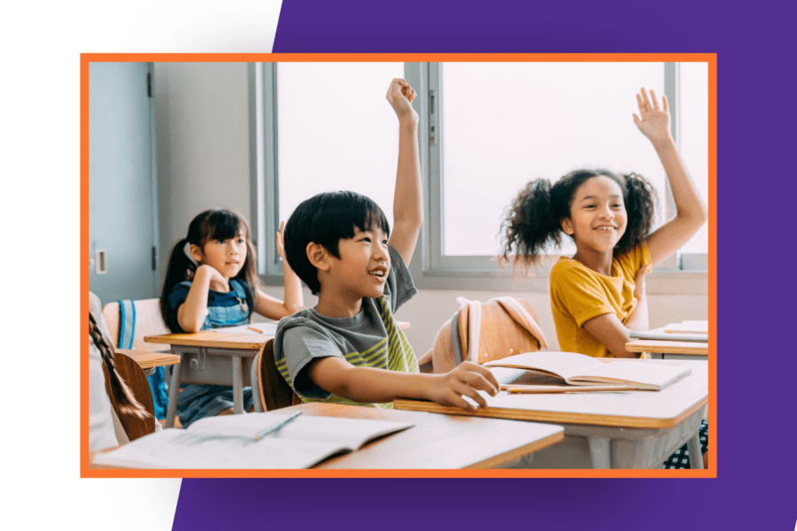 elementary students raising hands